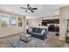 Inviting living room with a ceiling fan and easy access to the well-equipped kitchen and dining area at 7718 W Pipestone Pl, Phoenix, AZ 85035
