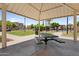 Community park picnic area with shaded seating, nearby swimming pool, and neighborhood homes at 7718 W Pipestone Pl, Phoenix, AZ 85035