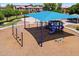 Community playground with swings, slides, and climbing structures under a shade structure at 7718 W Pipestone Pl, Phoenix, AZ 85035