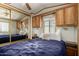 Comfortable bedroom with wood cabinetry, side table, and a mirrored closet at 7750 E Broadway Rd # 357, Mesa, AZ 85208