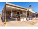 Inviting single-story home with a spacious carport and well-maintained yard and mature palm trees at 7750 E Broadway Rd # 357, Mesa, AZ 85208