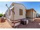 Exterior view of the home featuring a satellite dish, stairs, and air conditioner at 7750 E Broadway Rd # 357, Mesa, AZ 85208
