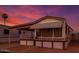 Charming single-story home featuring a covered porch and a beautifully colored sky at 7750 E Broadway Rd # 357, Mesa, AZ 85208