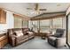 Relaxing living area with comfortable leather seating, ceiling fan, and plenty of natural light at 7750 E Broadway Rd # 357, Mesa, AZ 85208