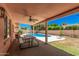 Backyard features a covered patio, sparkling pool, and lush landscaping to create a private oasis at 837 W Keating Ave, Mesa, AZ 85210