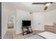 Bright bedroom featuring a ceiling fan and doorway to a bathroom at 837 W Keating Ave, Mesa, AZ 85210