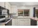 Well lit kitchen featuring laminate countertops, tile floors and view of dining area at 837 W Keating Ave, Mesa, AZ 85210