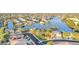 Aerial view of a neighborhood with lake, palm trees, and single Gathering homes at 8759 W Port Au Prince Ln, Peoria, AZ 85381