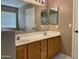 Bathroom featuring double sinks, natural lighting, and tile flooring at 8759 W Port Au Prince Ln, Peoria, AZ 85381