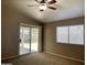 Inviting bedroom featuring a sliding glass door to the backyard and a window at 8759 W Port Au Prince Ln, Peoria, AZ 85381