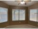 Well-lit bedroom featuring tiled floor, three large windows with blinds for optimal brightness at 8759 W Port Au Prince Ln, Peoria, AZ 85381