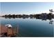 Beautiful lake view featuring a private dock and serene waterfront homes at 8759 W Port Au Prince Ln, Peoria, AZ 85381