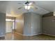 Inviting living room with tiled floors, ceiling fan, and neutral paint, offering a bright and spacious feel at 8759 W Port Au Prince Ln, Peoria, AZ 85381