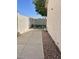 Side yard featuring concrete walk and gravel ground cover at 8759 W Port Au Prince Ln, Peoria, AZ 85381