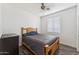 Comfortable bedroom with a window, wood floors, and a ceiling fan at 10961 W Chase Ln, Avondale, AZ 85323