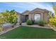 Charming single-story home with manicured landscaping and green lawn at 10961 W Chase Ln, Avondale, AZ 85323