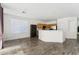 Bright, open-concept room with a kitchen, breakfast bar, and dining area at 10961 W Chase Ln, Avondale, AZ 85323