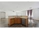 Kitchen with a breakfast bar overlooking an open-concept room with wood floors at 10961 W Chase Ln, Avondale, AZ 85323