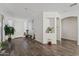 Bright living room with dark wood floors, white walls, and lots of plants at 10961 W Chase Ln, Avondale, AZ 85323