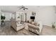 Open-concept living room with neutral tones, wood floors, and cozy seating at 10961 W Chase Ln, Avondale, AZ 85323