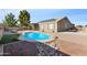 Backyard oasis featuring a sparkling blue pool, built-in bar, and outdoor entertaining area at 10961 W Chase Ln, Avondale, AZ 85323