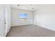Spacious bedroom features neutral carpet, large window, and white walls at 11215 E Crescent Ave, Mesa, AZ 85208