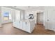 Open kitchen features white cabinetry, a large island and stainless appliances at 11215 E Crescent Ave, Mesa, AZ 85208