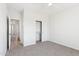 Bright bedroom features a closet, neutral walls, carpet floors, and a doorway leading to another room at 11227 E Crescent Ave, Mesa, AZ 85208