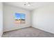 Bedroom features carpet floors, a ceiling fan, and a window with views of the neighborhood at 11227 E Crescent Ave, Mesa, AZ 85208