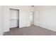 This bedroom features a closet with sliding doors, neutral walls, carpet floors, and access to another room at 11227 E Crescent Ave, Mesa, AZ 85208