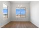 Dining room featuring wood-look flooring, neutral paint, and natural light at 11227 E Crescent Ave, Mesa, AZ 85208