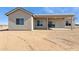 Rear view of desert home, showcasing a covered patio and neutral-colored exterior at 11227 E Crescent Ave, Mesa, AZ 85208