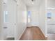 Inviting foyer with wood-look flooring, natural light, and neutral paint at 11227 E Crescent Ave, Mesa, AZ 85208