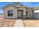 Single-story home featuring a gray front entrance with brick accents and desert landscaping at 11227 E Crescent Ave, Mesa, AZ 85208