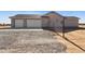 A three car garage at the end of a long driveway on a home in a rural setting at 11227 E Crescent Ave, Mesa, AZ 85208