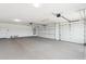 Open three car garage with concrete flooring and automatic doors, plus installed water heater at 11227 E Crescent Ave, Mesa, AZ 85208