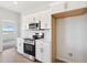Modern kitchen featuring white cabinets, quartz countertops, and stainless steel appliances at 11227 E Crescent Ave, Mesa, AZ 85208