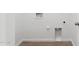 A utility room with hook ups for a washer and dryer on a wall painted white at 11227 E Crescent Ave, Mesa, AZ 85208