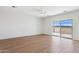 Bright living space featuring wood-look flooring and a sliding glass door at 11227 E Crescent Ave, Mesa, AZ 85208