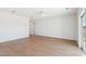 Large living space featuring wood-look flooring, neutral paint, and plenty of natural light at 11227 E Crescent Ave, Mesa, AZ 85208