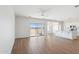 Open-concept living space with wood-look flooring and a sliding glass door at 11227 E Crescent Ave, Mesa, AZ 85208