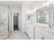 Bright main bathroom featuring double vanity sinks, glass shower, and white marble at 11227 E Crescent Ave, Mesa, AZ 85208