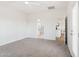 Bright main bedroom featuring neutral carpet with ensuite bathroom and access to the backyard at 11227 E Crescent Ave, Mesa, AZ 85208