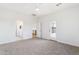 Bright main bedroom featuring neutral carpet with ensuite bathroom and access to the backyard at 11227 E Crescent Ave, Mesa, AZ 85208