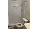The bathroom is all white and has a tile shower with a built-in shelf at 11849 N 29Th Ave, Phoenix, AZ 85029