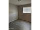 The bedroom has a window with wood-look floors and light gray walls at 11849 N 29Th Ave, Phoenix, AZ 85029