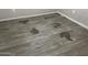 The gray laminate floor is damaged and has several holes in it at 11849 N 29Th Ave, Phoenix, AZ 85029
