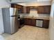 Updated kitchen features stainless steel appliances and wooden cabinets at 11849 N 29Th Ave, Phoenix, AZ 85029