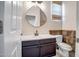Well-lit bathroom featuring a modern vanity, toilet, neutral paint, and stylish fixtures at 11936 W Alvarado Rd, Avondale, AZ 85392