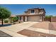 Charming two-story home with a manicured lawn, paved driveway, and an attached two-car garage at 11936 W Alvarado Rd, Avondale, AZ 85392